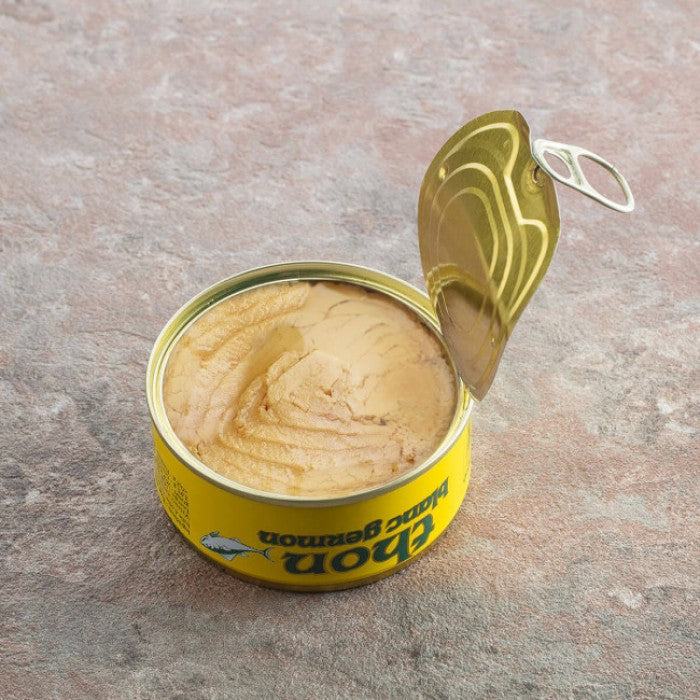 Opened can of Thon albacore tuna preserved in premium olive oil, a gourmet seafood treat.